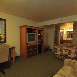 Day use room with work desk and sofa at Shilo Inn Rose Garden.

