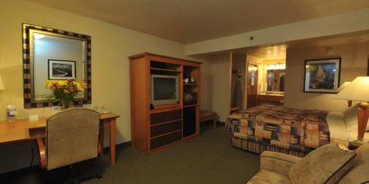Day use room with work desk and sofa at Shilo Inn Rose Garden.
