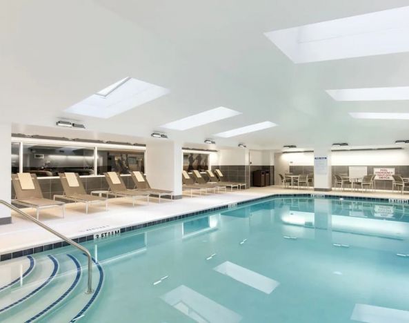 Stunning indoor pool with pool chairs at Hyatt Place Charleston - Historic District.