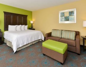 King bed with lounge area at Hampton Inn Iowa City/University Area.