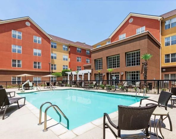 Stunning outdoor pool with pool chairs at Homewood Suites By Hilton Shreveport.