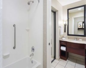 Guest bathroom with shower and bath at Homewood Suites By Hilton Shreveport.