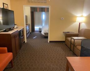 Spacious king bed with TV and lounge area at Holiday Inn Express & Suites Scottsdale - Old Town.
