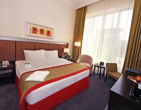 Delux king room with natural light at Millennium Central Doha.