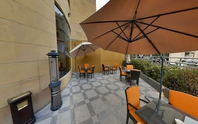 Outdoor terrace and coworking space at Millennium Central Doha.