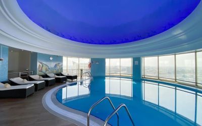 Relaxing indoor pool and pool area at Millennium Hotel Doha.