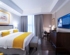 King bed with TV at Millennium Hotel Doha.