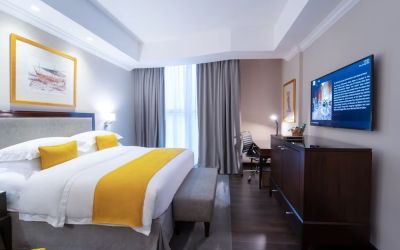 King bed with TV at Millennium Hotel Doha.