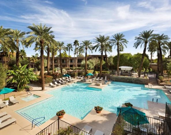 Relaxing outdoor pool with pool chairs at DoubleTree Resort By Hilton Paradise Valley - Scottsdale.