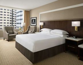 King bed with natural light at Hilton Indianapolis Hotel & Suites.