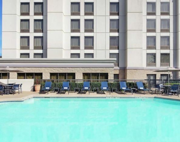 Relaxing pool area with pool chairs at Hampton Inn Dallas-Irving-Las Colinas.