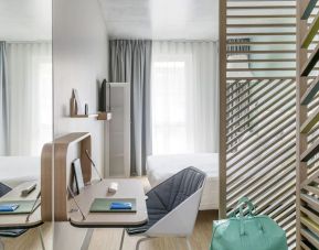 King bed with natural light at OKKO Hotels Nice Aéroport.