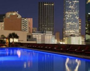 Stunning outdoor pool with sunbeds at Fairmont Dallas.