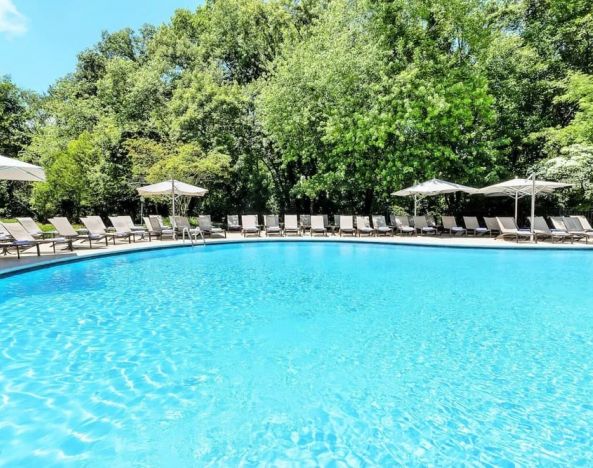 Luxurious outdoor pool with pool chairs at Hilton Short Hills.