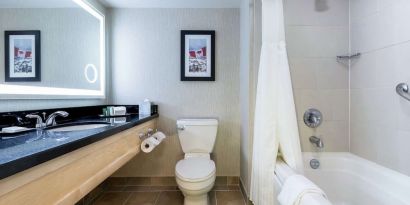 Guest bathroom with shower and bath at Hilton Whistler Resort & Spa.