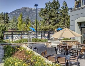 Outdoor terrace set in a lovely garden at Hilton Whistler Resort & Spa.