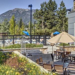 Outdoor terrace set in a lovely garden at Hilton Whistler Resort & Spa.