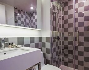 Guest bathroom with shower at Best Western Premier Empire State Hotel.