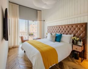 Comfortable king bedroom with TV at The Williamsburg Hotel.