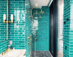 Luxurious guest bathroom with shower at The Williamsburg Hotel.