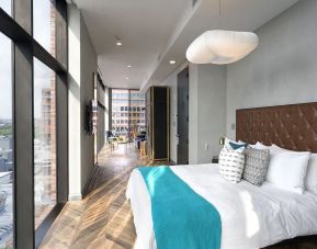 Spacious king bed with city views at The Williamsburg Hotel.