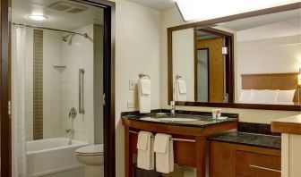 Guest bathroom with shower and tub at Hyatt Place Fort Lauderdale Cruise Port.