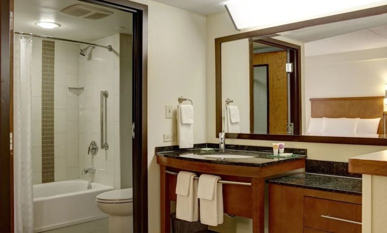 Guest bathroom with shower and tub at Hyatt Place Fort Lauderdale Cruise Port.
