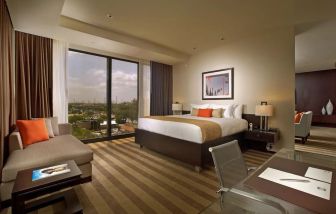 Day use room with work desk and sofa at EB Hotel Miami.