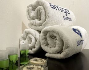 Guest bathroom with towels and toiletries at Hotel Amigo Suites.