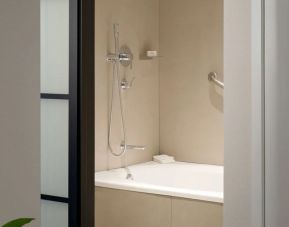 Guest bathroom with shower and bath combo at Sheraton Park Hotel At The Anaheim Resort.