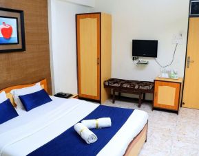 Delux king bed with TV at Hotel Alka Residency.