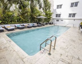 Relaxing pool area with sun loungers at Hotel Croydon.