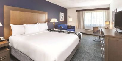 Day use room with work desk and sofa at La Quinta Inn & Suites By Wyndham Philadelphia Airport.
