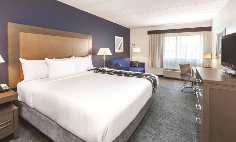 Day use room with work desk and sofa at La Quinta Inn & Suites By Wyndham Philadelphia Airport.
