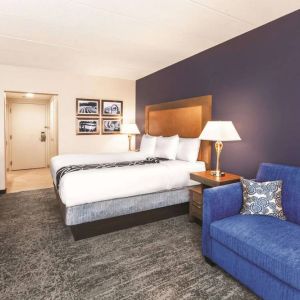 Day use room with TV and sofa at La Quinta Inn & Suites By Wyndham Philadelphia Airport.