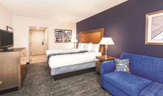 Day use room with TV and sofa at La Quinta Inn & Suites By Wyndham Philadelphia Airport.