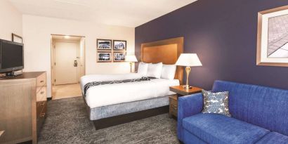 Day use room with TV and sofa at La Quinta Inn & Suites By Wyndham Philadelphia Airport.