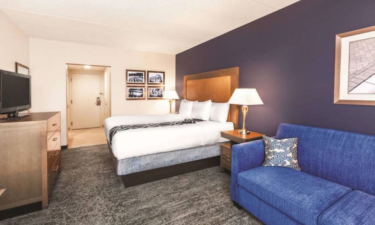 Day use room with TV and sofa at La Quinta Inn & Suites By Wyndham Philadelphia Airport.