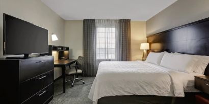 King bed with TV at Staybridge Suites Washington D.C.- Greenbelt.