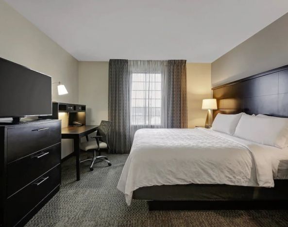 King bed with TV at Staybridge Suites Washington D.C.- Greenbelt.