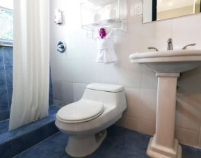 Guest bathroom with shower at Hollywood Beach Suites, A South Beach Group Hotel.