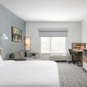Bright-lit day use room with work desk and sofa at TownePlace Suites Nashville Midtown.