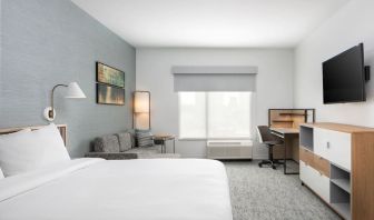 Bright-lit day use room with work desk and sofa at TownePlace Suites Nashville Midtown.