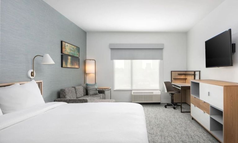 Bright-lit day use room with work desk and sofa at TownePlace Suites Nashville Midtown.