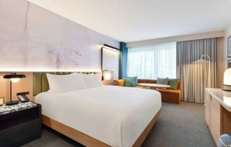 King bed room with natural light at Kimpton Hotel Theta.
