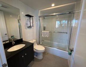 Guest bathroom with shower at Regal Inn & Suites New York.