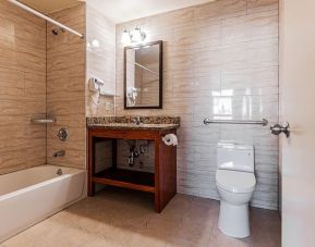 Guest bathroom with shower at Astoria Inn LaGuardia Hotel.