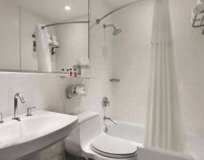 Guest bathroom with shower at Night Hotel Broadway.