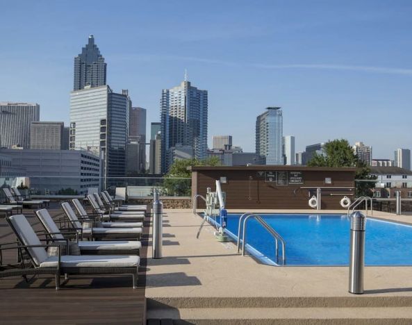 Stunning outdoor pool with pool loungers at Crowne Plaza Atlanta-Midtown.