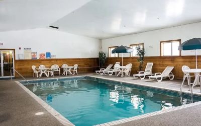 Indoor pool with pool chairs at Norwood Inn & Suites - Roseville.